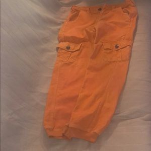 Orange pants true religion with black spot on butt